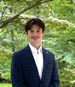 Male student standing outside in forrest