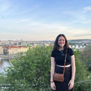 Female student standing overlooking river and city